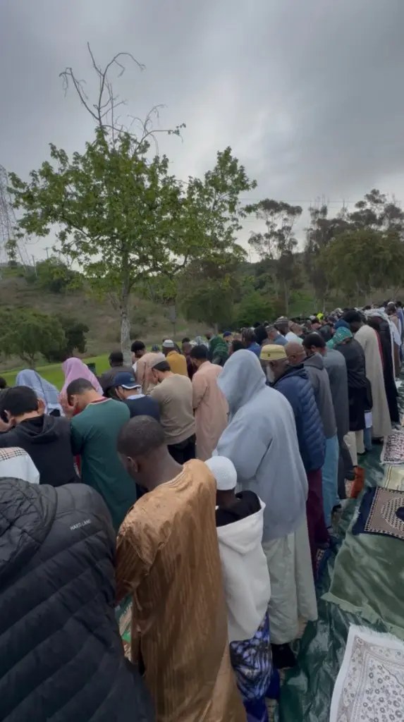 Masjid Al-Mumin community praying together outdoors
